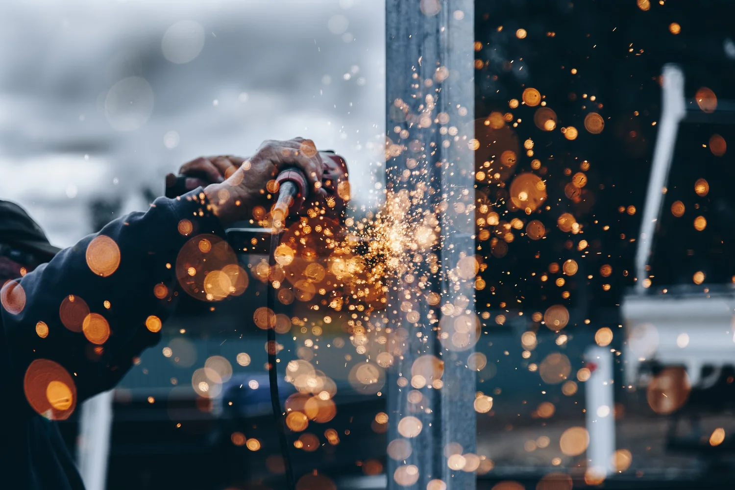 Sparks flying as a worker grinds metal
