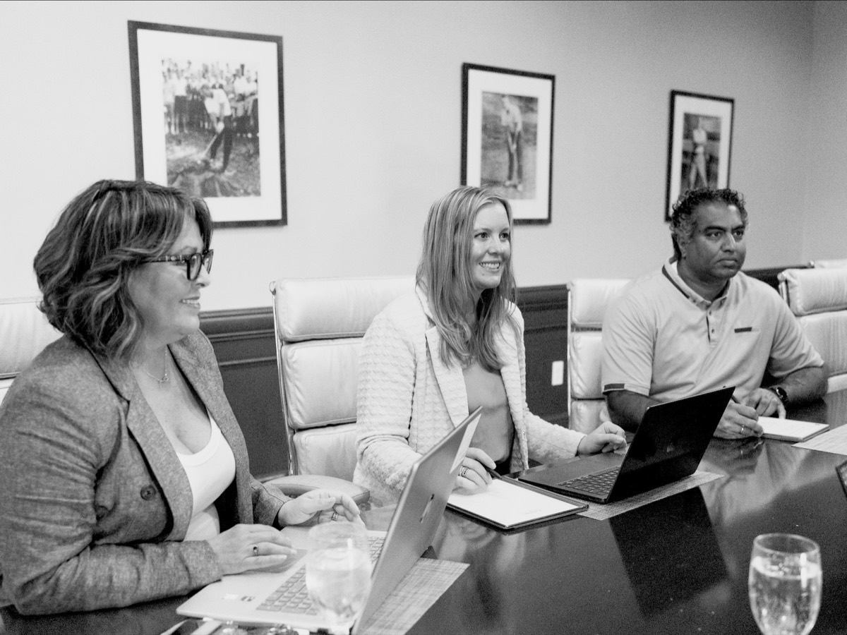 BlueTree team members in discussion around the boardroom table